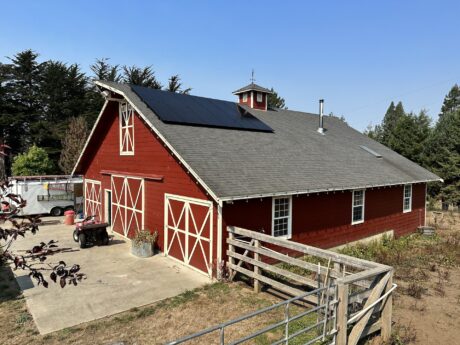 barn on a farm with all black solar panels