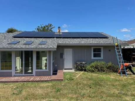 grey house with all new all black solar panel roof top insulation